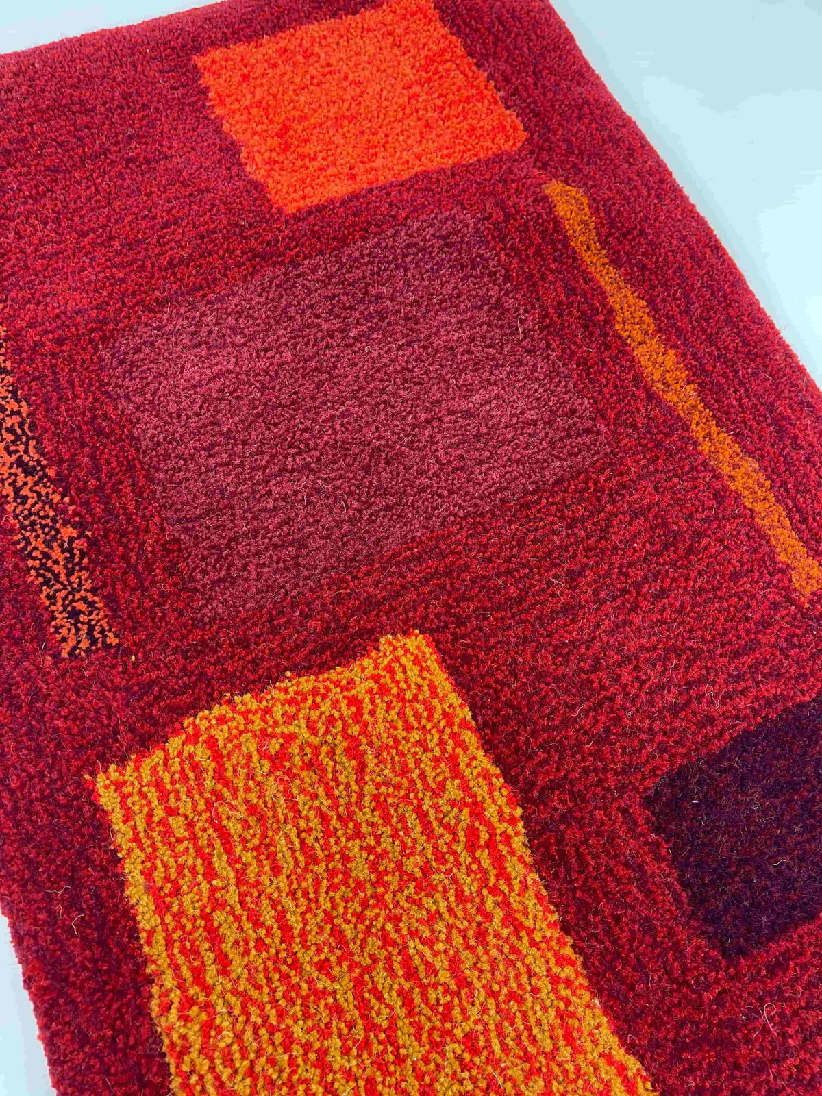 'Flare' Hand tufted burgundy, red and orange small tufted rug