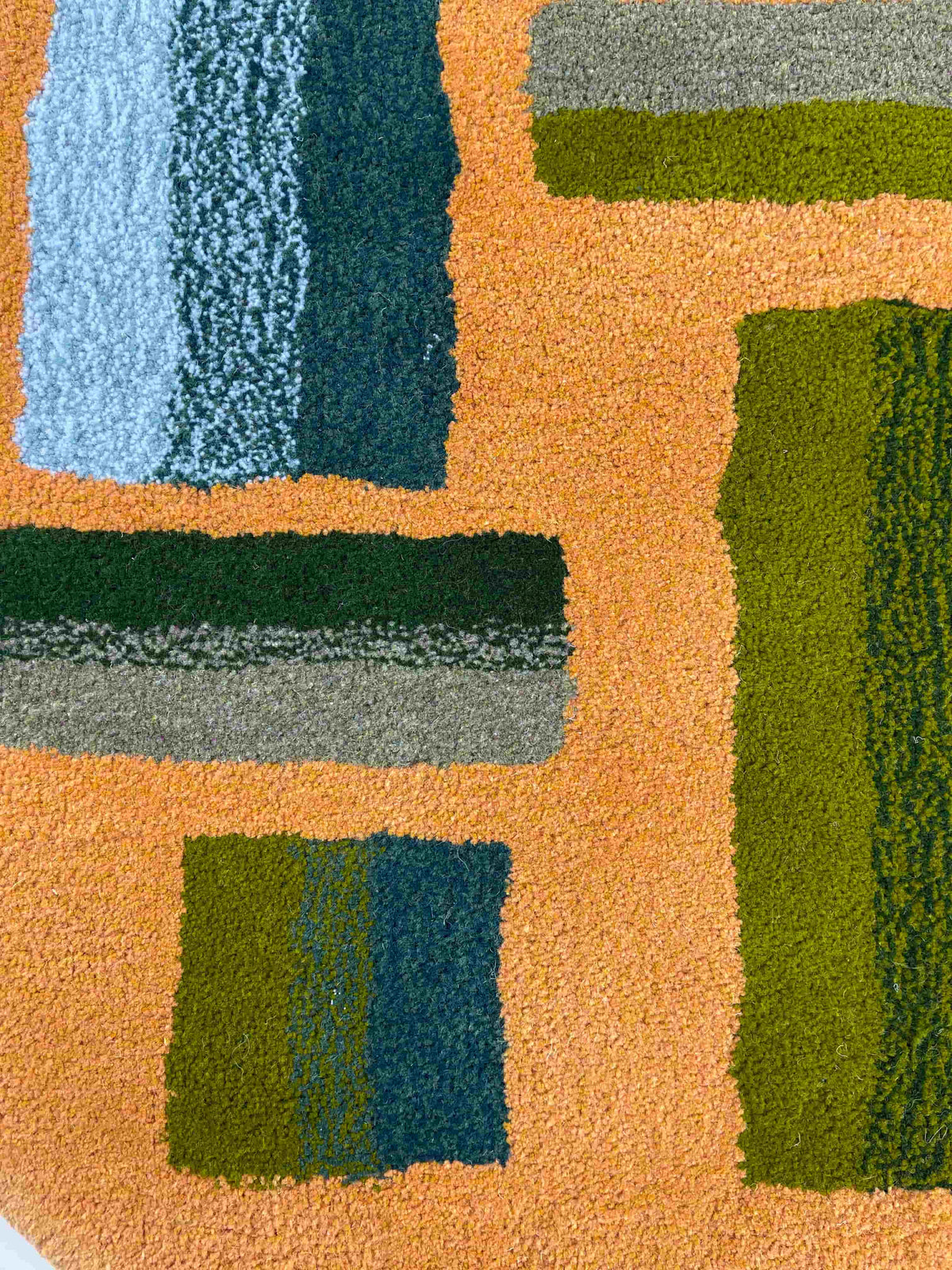 'Hitomi' Hand tufted ochre mustard, dark green and teal circular small tufted rug